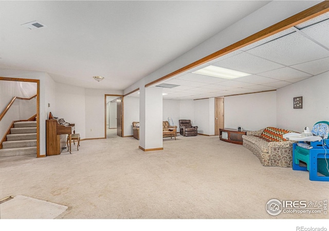 recreation room featuring a paneled ceiling and carpet flooring