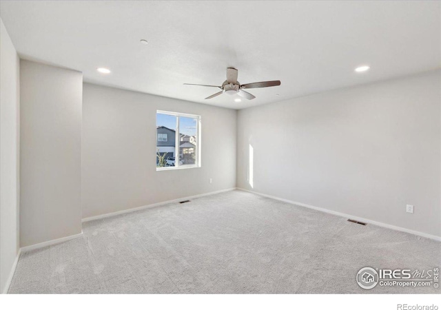 carpeted empty room featuring ceiling fan