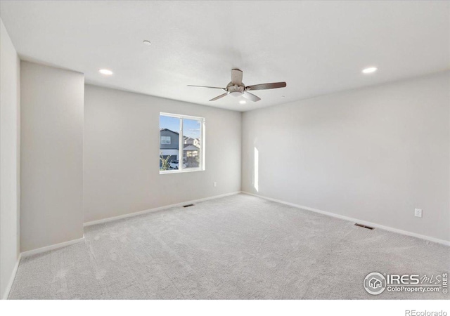 carpeted spare room with recessed lighting, baseboards, visible vents, and ceiling fan