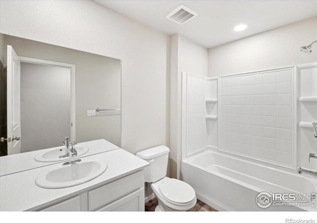 full bathroom featuring vanity, bathtub / shower combination, and toilet