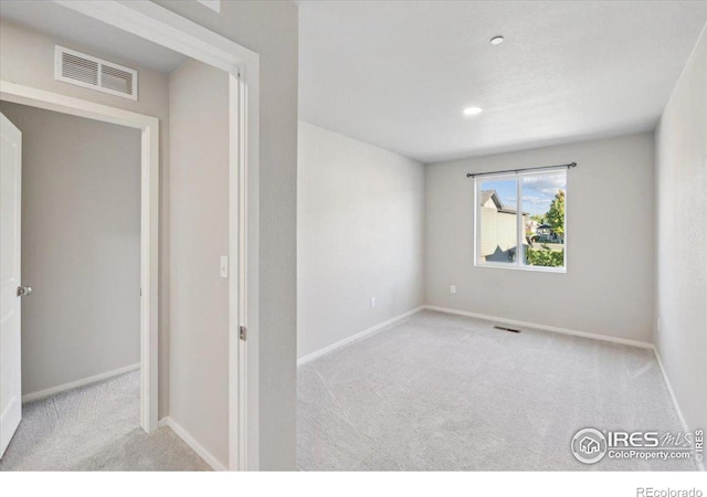 unfurnished room with light colored carpet