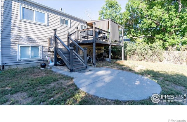 rear view of house featuring stairs, a wooden deck, and fence