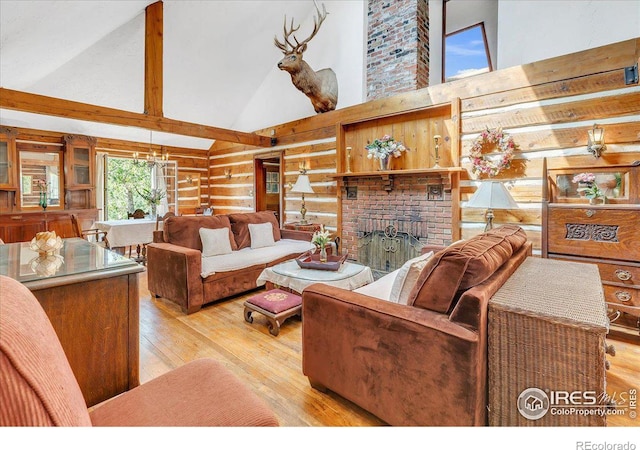 living room featuring high vaulted ceiling, hardwood / wood-style flooring, rustic walls, wooden walls, and a brick fireplace