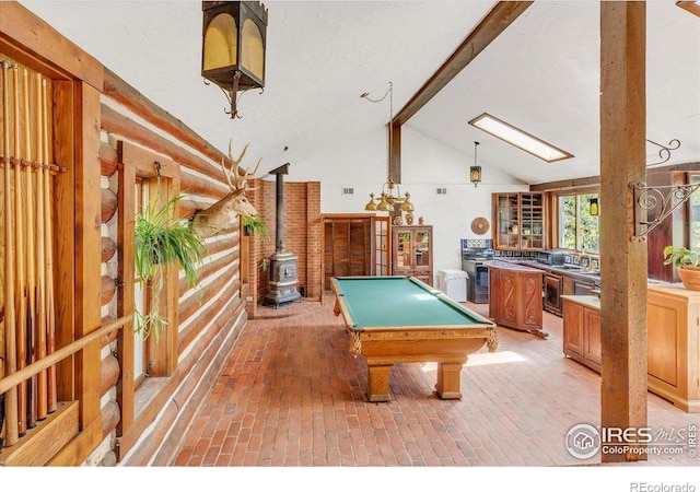 game room with lofted ceiling, pool table, and a wood stove