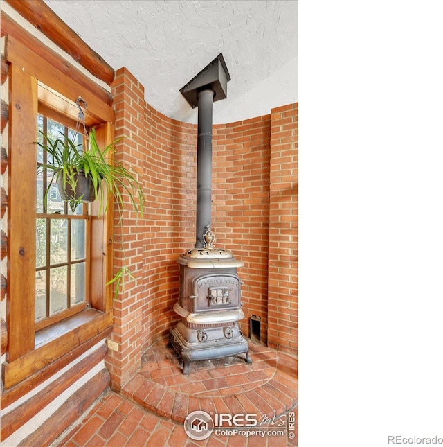 details with a wood stove and a textured ceiling