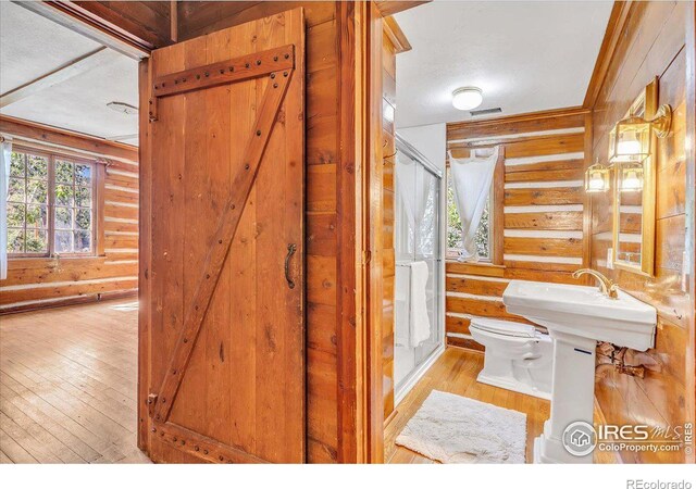 bathroom featuring wood-type flooring, toilet, sink, and a textured ceiling