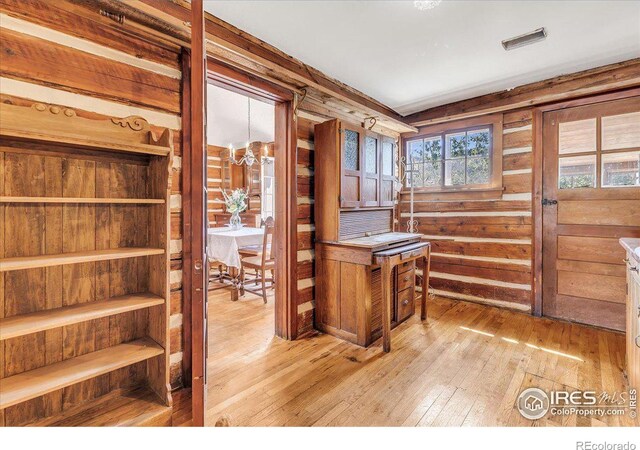 home office with light hardwood / wood-style floors