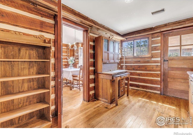 home office with visible vents, a notable chandelier, and light wood-style flooring