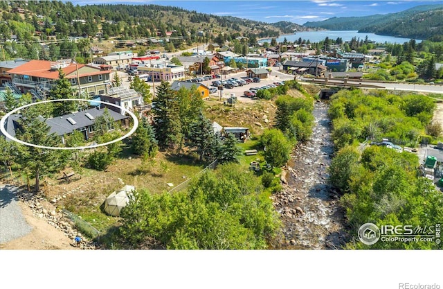 drone / aerial view featuring a water and mountain view