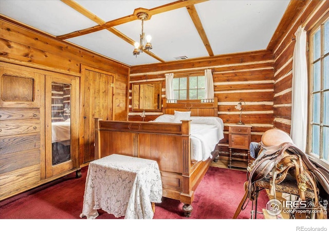 bedroom with visible vents, a chandelier, beamed ceiling, rustic walls, and dark colored carpet