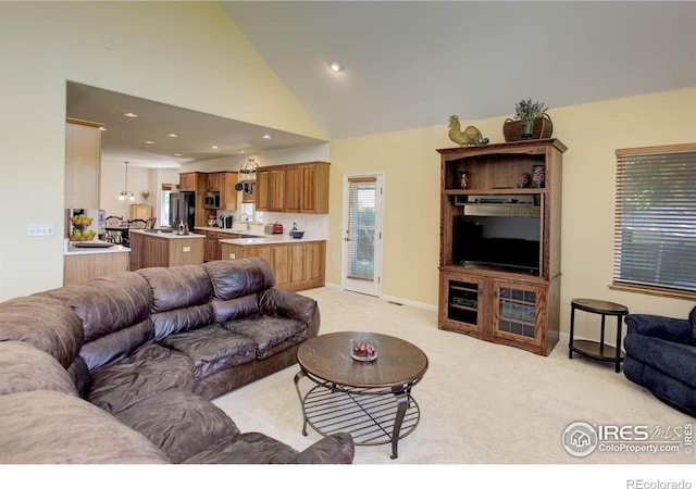 living area with light carpet, recessed lighting, high vaulted ceiling, and baseboards