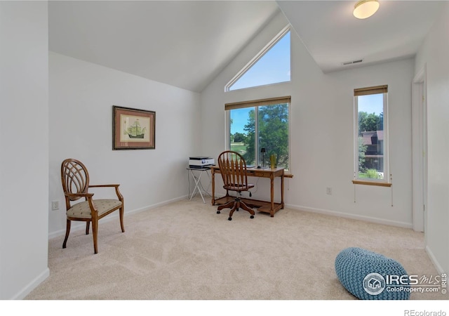 carpeted office space with visible vents, high vaulted ceiling, and baseboards