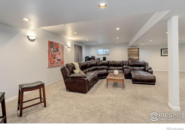 living room with recessed lighting, baseboards, and carpet