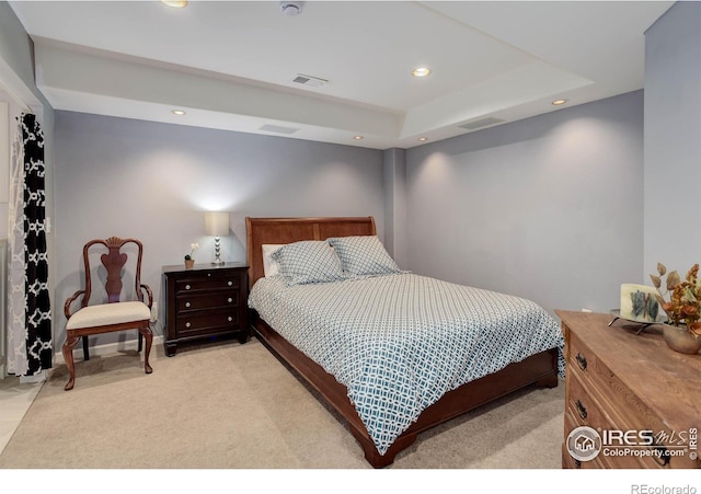 bedroom with recessed lighting, visible vents, light carpet, and a tray ceiling