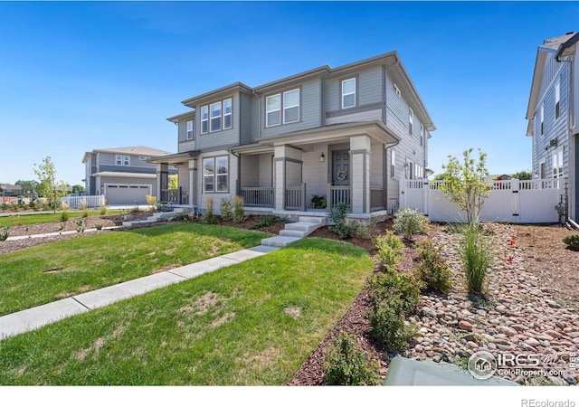 view of front of home featuring covered porch, a front lawn, fence, and a garage