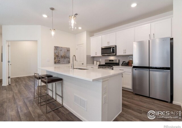 kitchen featuring white cabinets, stainless steel appliances, dark hardwood / wood-style floors, and sink