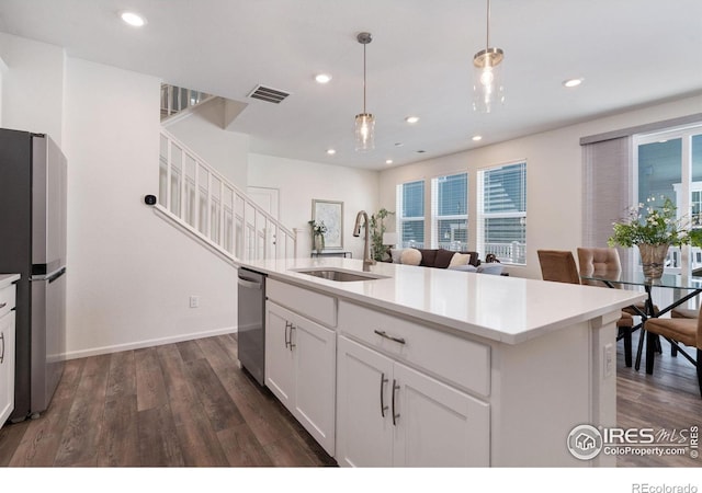 kitchen with recessed lighting, dark wood-style flooring, a sink, visible vents, and appliances with stainless steel finishes