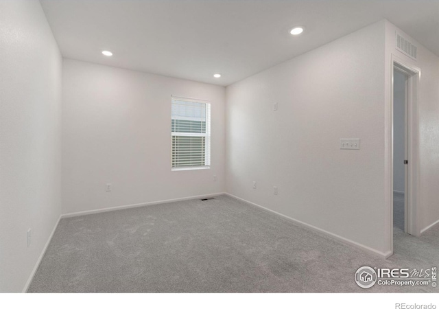 unfurnished room with baseboards, carpet floors, visible vents, and recessed lighting