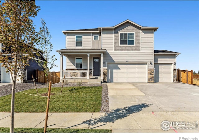 view of front of home featuring a porch, a garage, and a front lawn