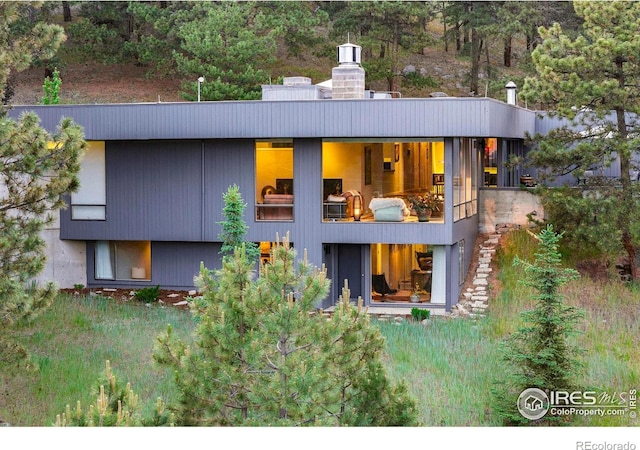 271 Anemone Dr, Boulder, CO 80302 - back of house featuring a balcony and a chimney