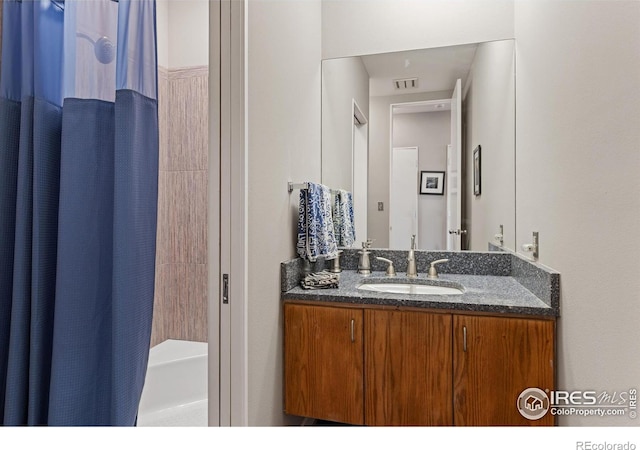 bathroom with vanity and shower / tub combo with curtain