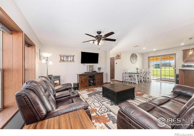 living room with visible vents, a ceiling fan, and light wood-style floors