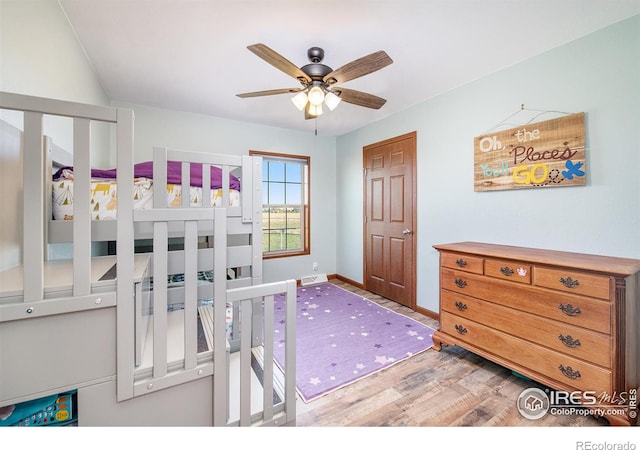 bedroom with baseboards and wood finished floors