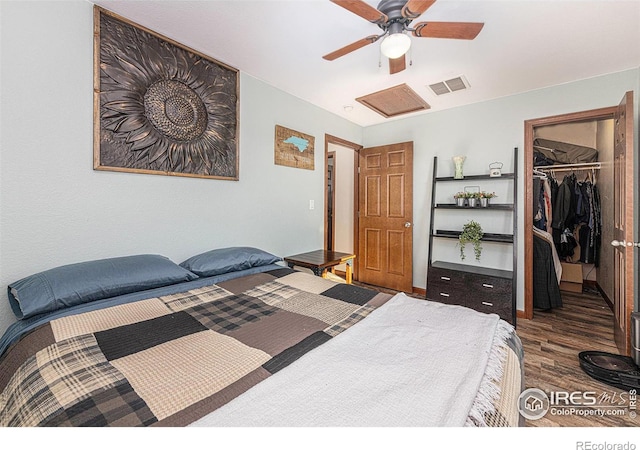 bedroom with attic access, visible vents, wood finished floors, a spacious closet, and a closet