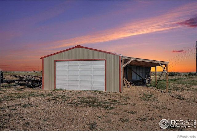 detached garage featuring dirt driveway