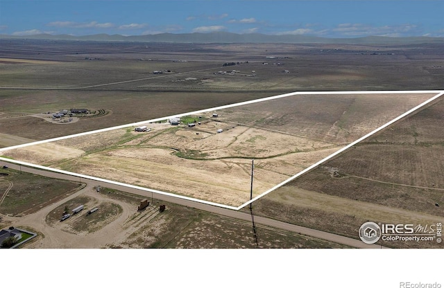 drone / aerial view featuring a rural view and a mountain view