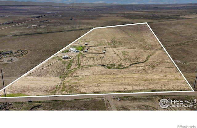 birds eye view of property featuring a rural view