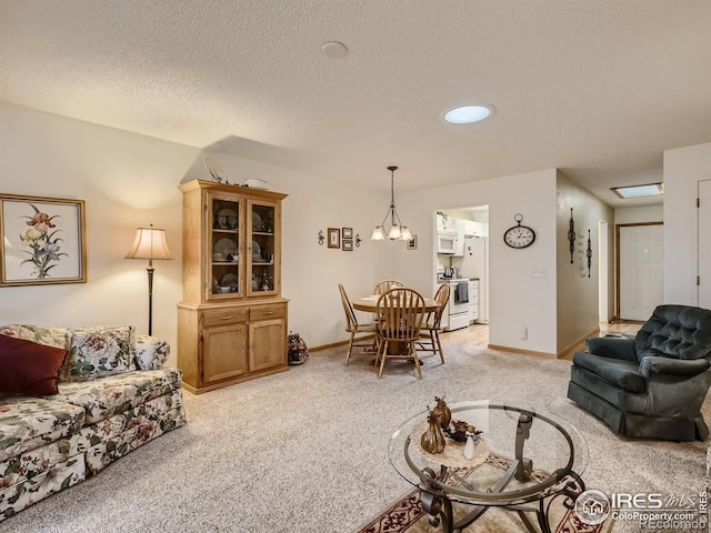 living room with baseboards, light carpet, a textured ceiling, and a chandelier