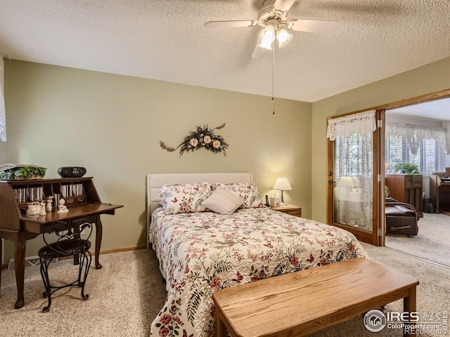 bedroom featuring a textured ceiling, a ceiling fan, baseboards, and light carpet