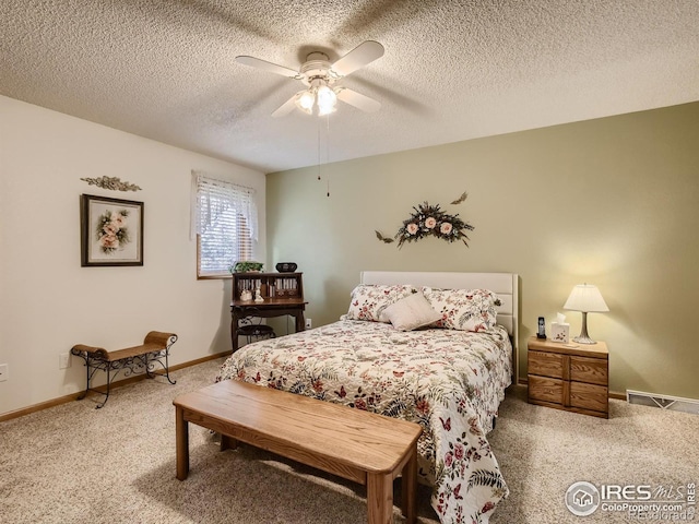 bedroom with light colored carpet, a textured ceiling, baseboards, and ceiling fan