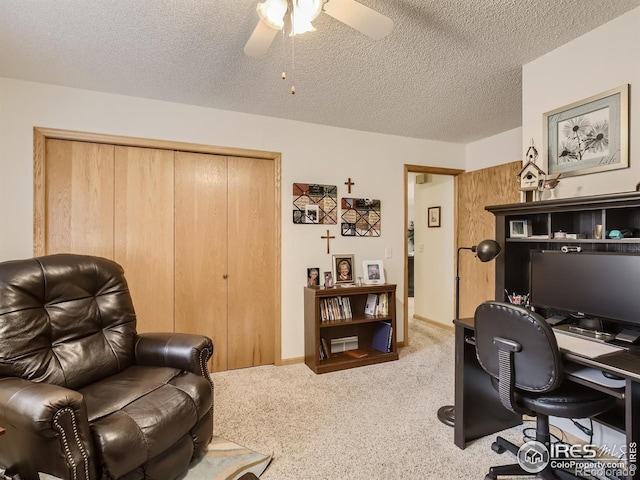 office with a ceiling fan, carpet, baseboards, and a textured ceiling