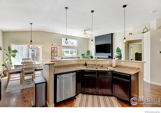 kitchen featuring vaulted ceiling, dark hardwood / wood-style flooring, sink, ceiling fan, and stainless steel dishwasher