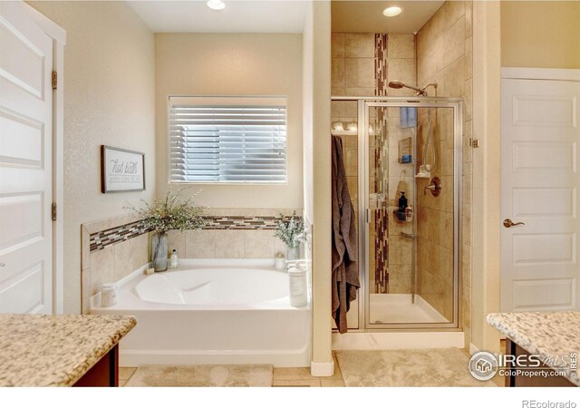 bathroom with vanity, separate shower and tub, and tile patterned floors