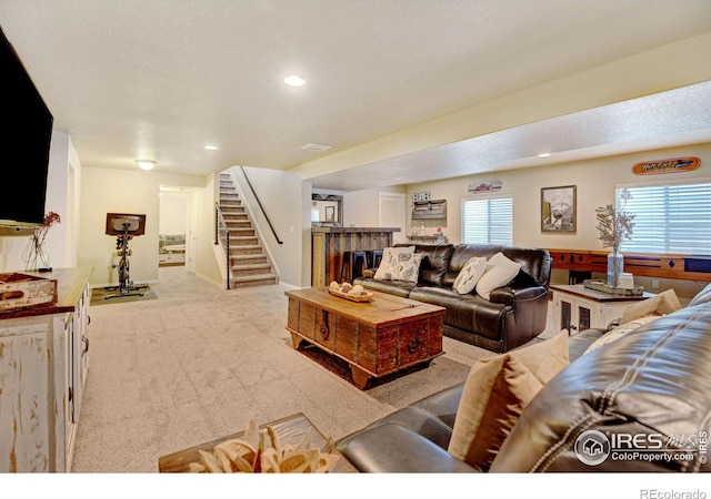 carpeted living room with a textured ceiling