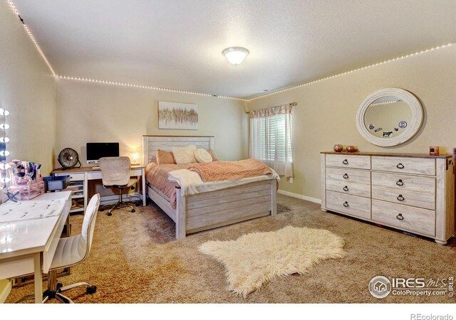 bedroom with a textured ceiling and carpet flooring