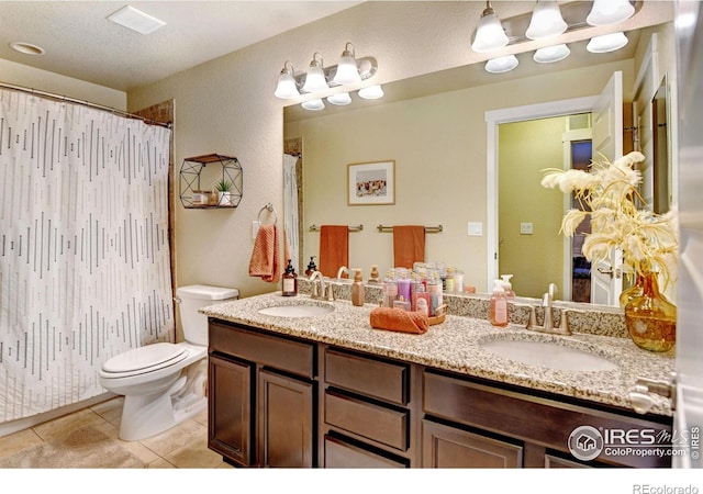 bathroom featuring toilet, walk in shower, tile patterned floors, vanity, and a textured ceiling