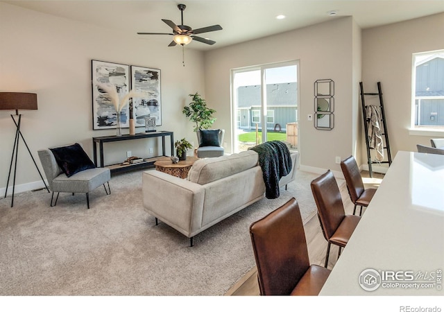 living room featuring ceiling fan and light carpet