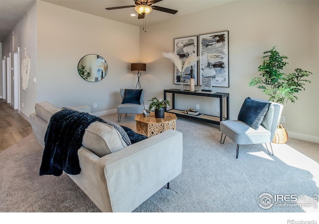 living room featuring ceiling fan and hardwood / wood-style floors