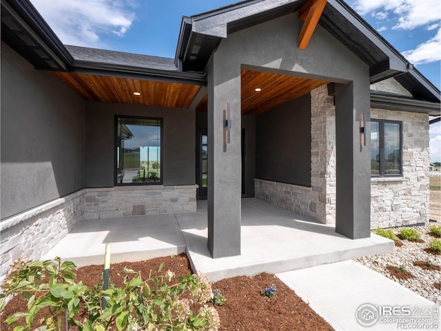 view of exterior entry featuring a patio area