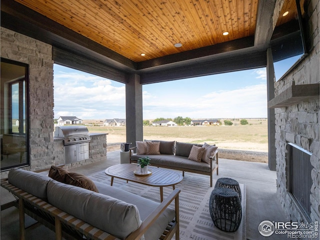 view of patio with an outdoor hangout area, exterior kitchen, and grilling area