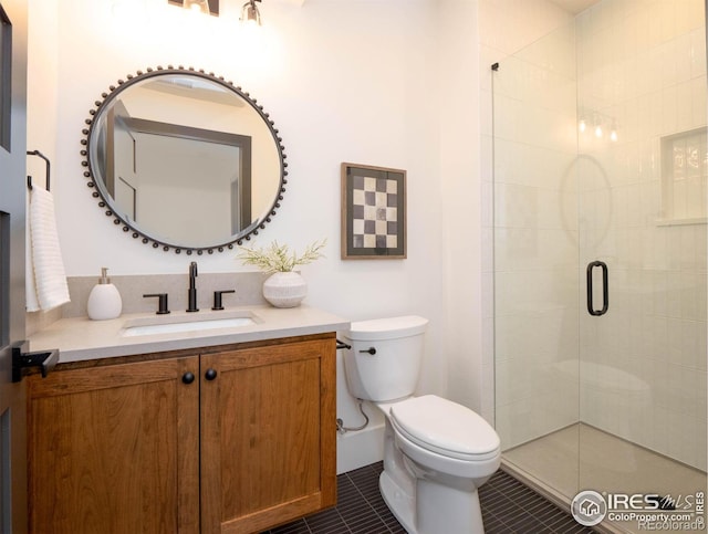 bathroom with toilet, tile patterned flooring, vanity, and a shower with door