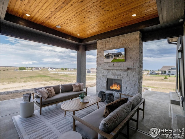 view of patio featuring an outdoor living space with a fireplace