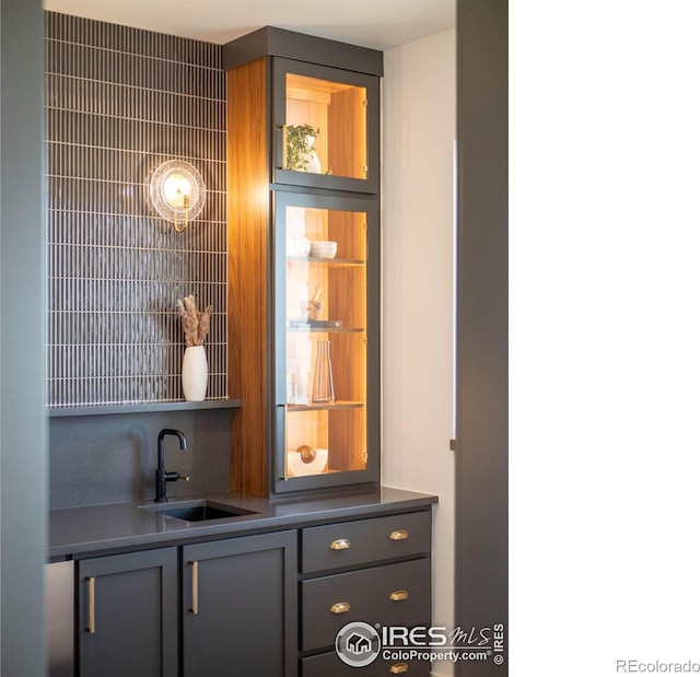 bar featuring gray cabinetry and sink