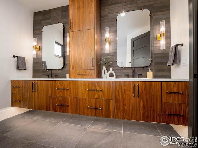 bathroom with vanity, decorative backsplash, and tile patterned flooring