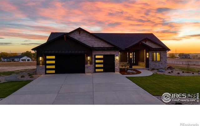 craftsman inspired home featuring a garage and a lawn