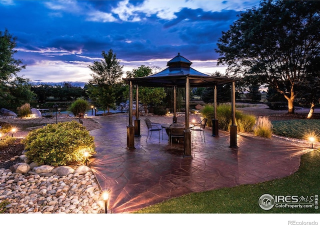 patio terrace at dusk featuring a gazebo